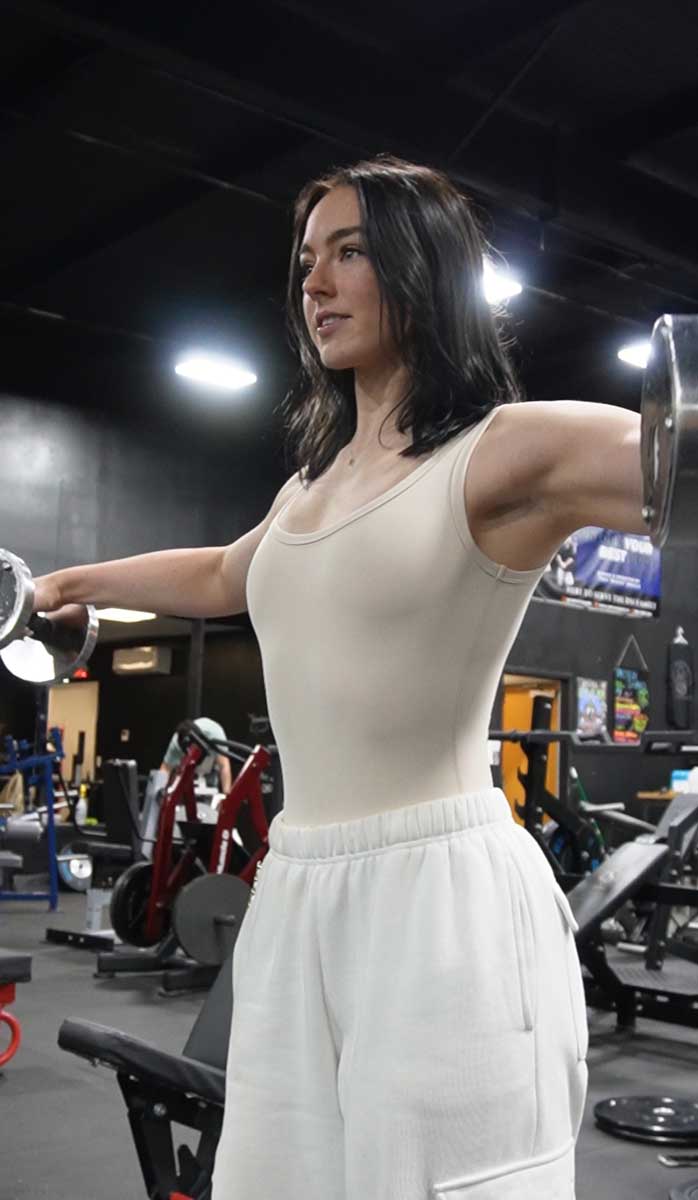 The coach is posing with the trophy.